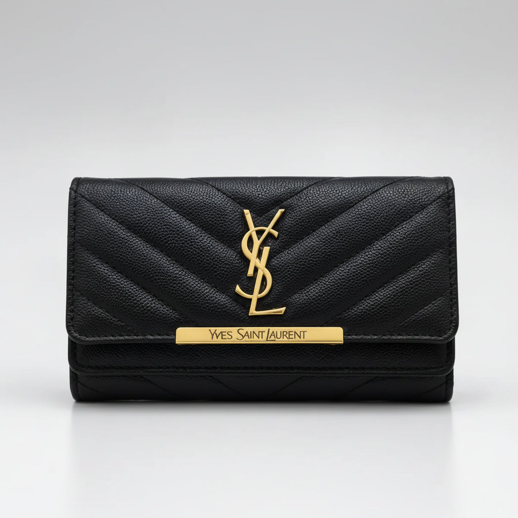 A navy blue quilted leather wallet by Yves Saint Laurent, featuring a gold-tone YSL monogram logo and a gold-tone brand plaque on the front flap, set against a neutral gray background.
