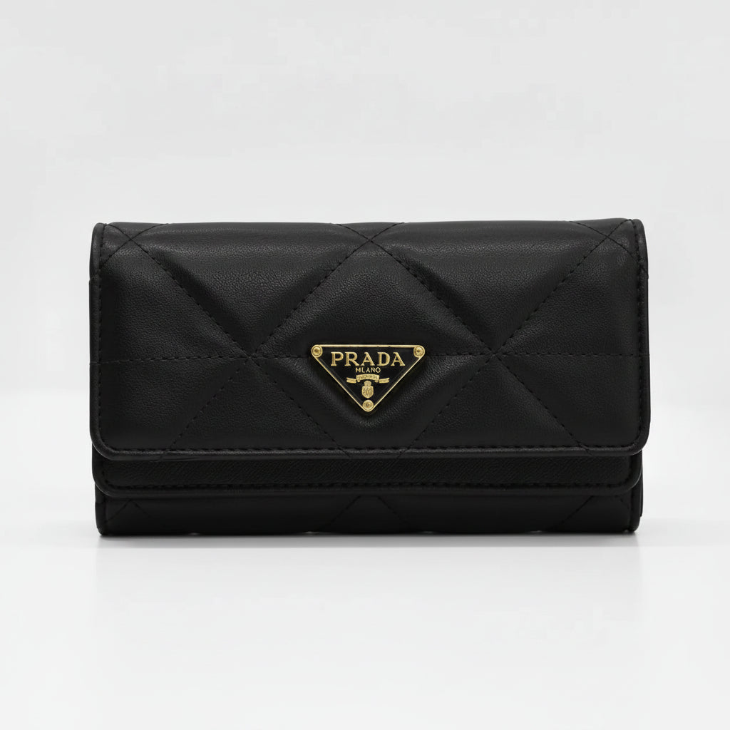 A black Prada quilted wallet with a gold-tone triangular logo plaque on the front, set against a plain light gray background.