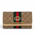Gucci monogram canvas wallet in beige with a green and red web stripe, gold interlocking G logo, and a gold metal bar engraved with the brand name.