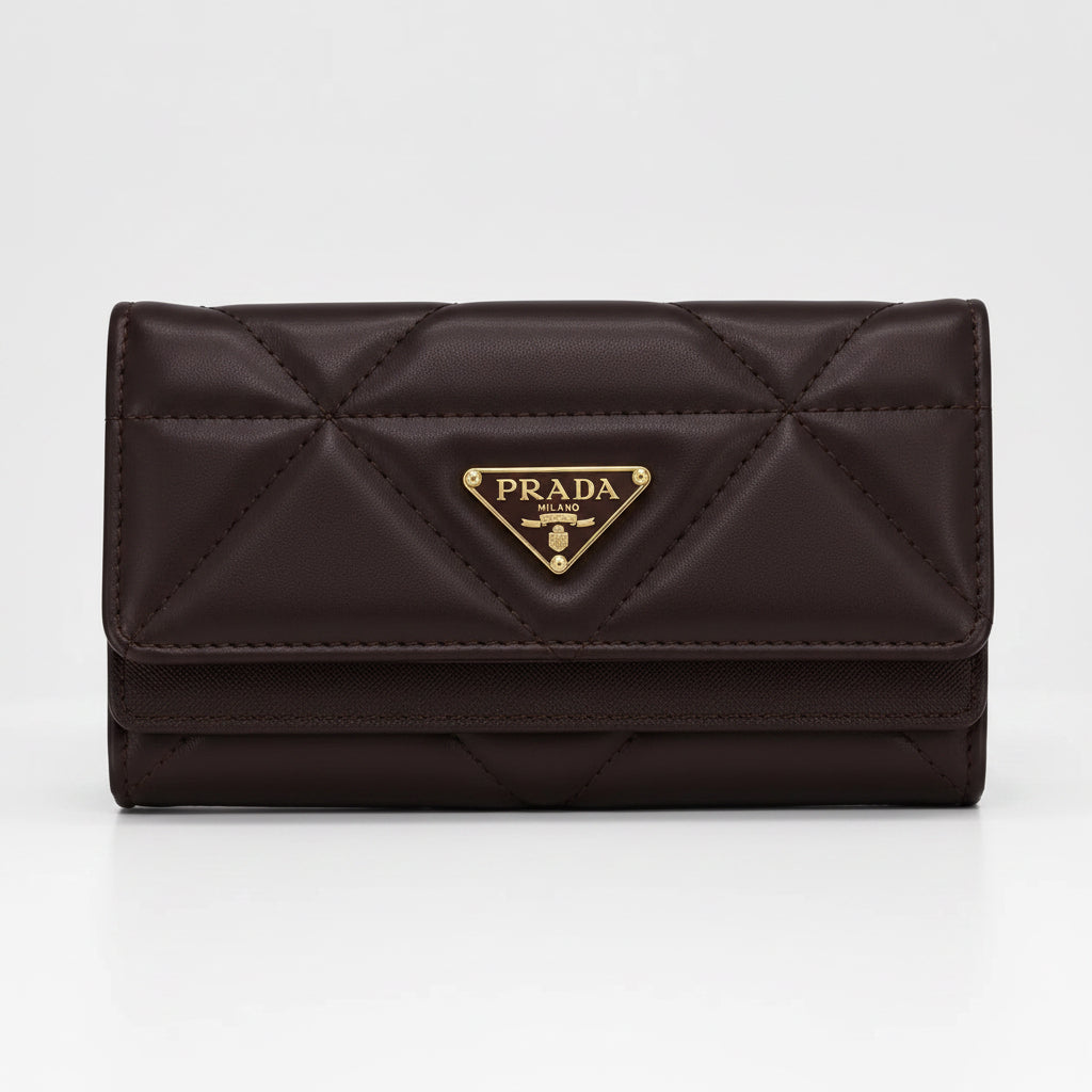 A dark brown Prada quilted leather wallet with a gold-tone triangular logo plaque on the front, set against a plain light gray background.