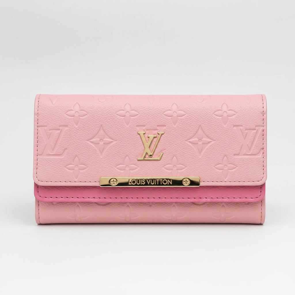 A pink Louis Vuitton monogram wallet with a gold-tone metal bar engraved with 'LOUIS VUITTON' and an embossed LV logo on the front flap, set against a plain light gray background.