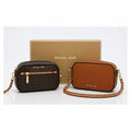 Two Michael Kors crossbody bags, one brown and one logo print, with a gift box.